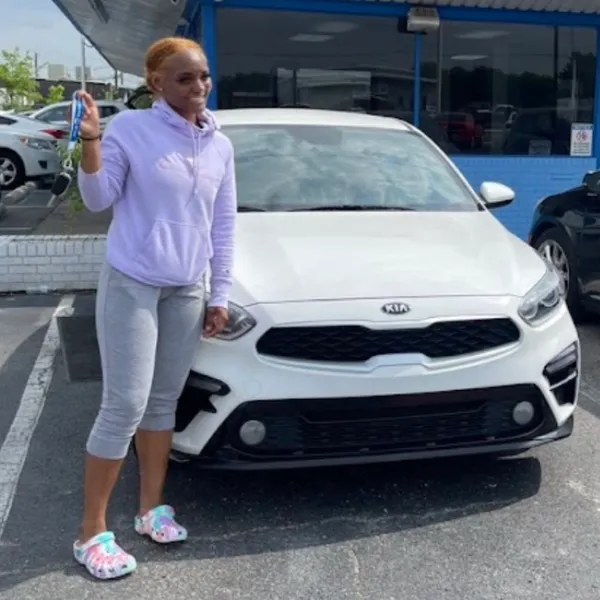Customer showing off keys to her new Kia Forte